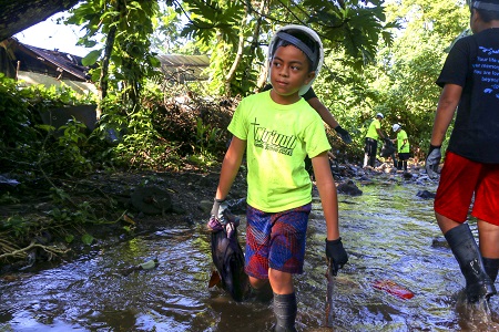 Taking trash out of stream in Nuuuli