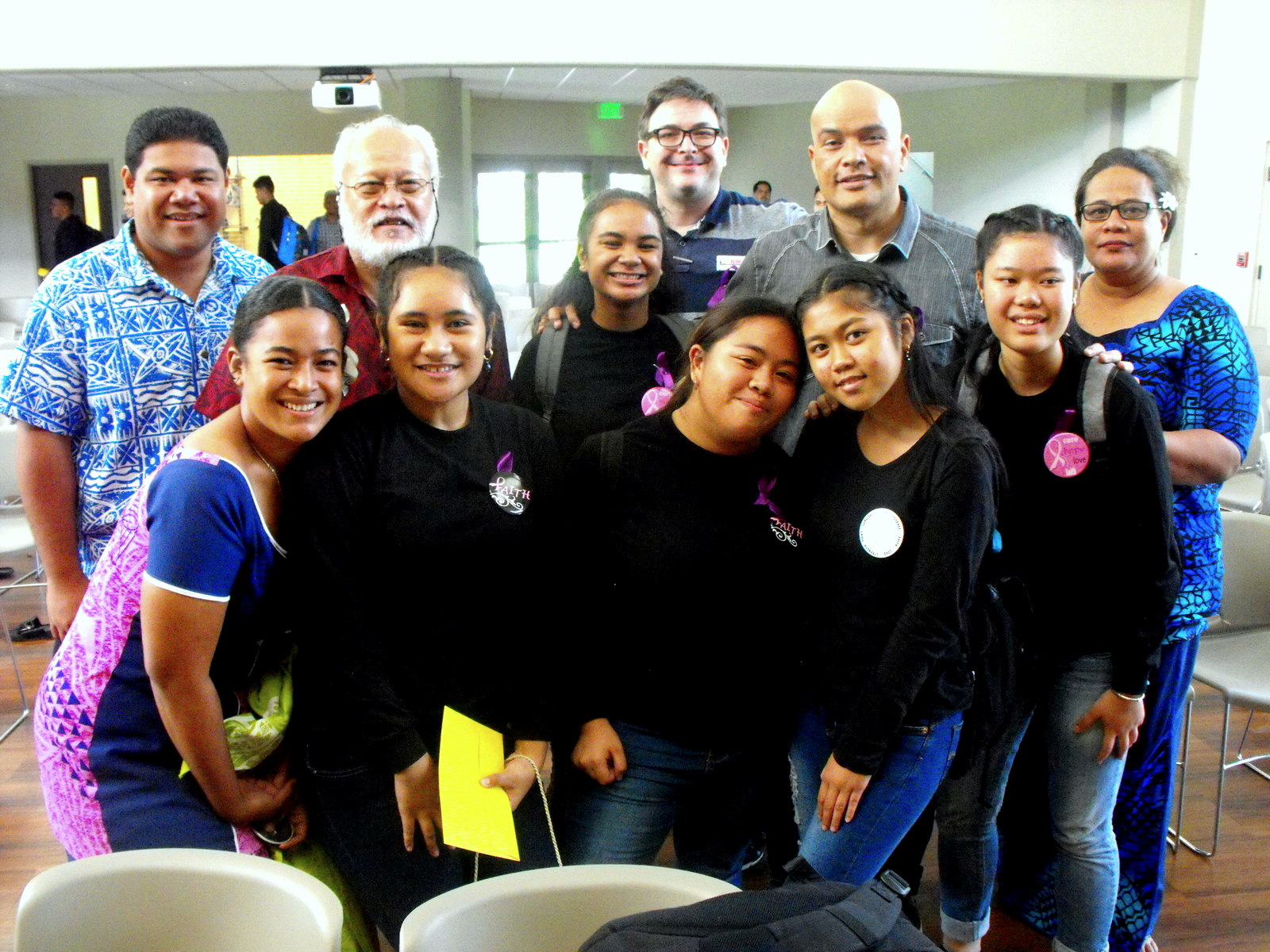 members of the judges panel congratulate the Samoana High School students (front, in black t-shirts) who took first place in the “Liuliu le Tofa” Poetry Slam